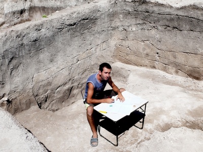 Студент 5-го курса Талех Алиев чертит порядок залегания почвенных слоёв в раскопе Тайны древних катакомб